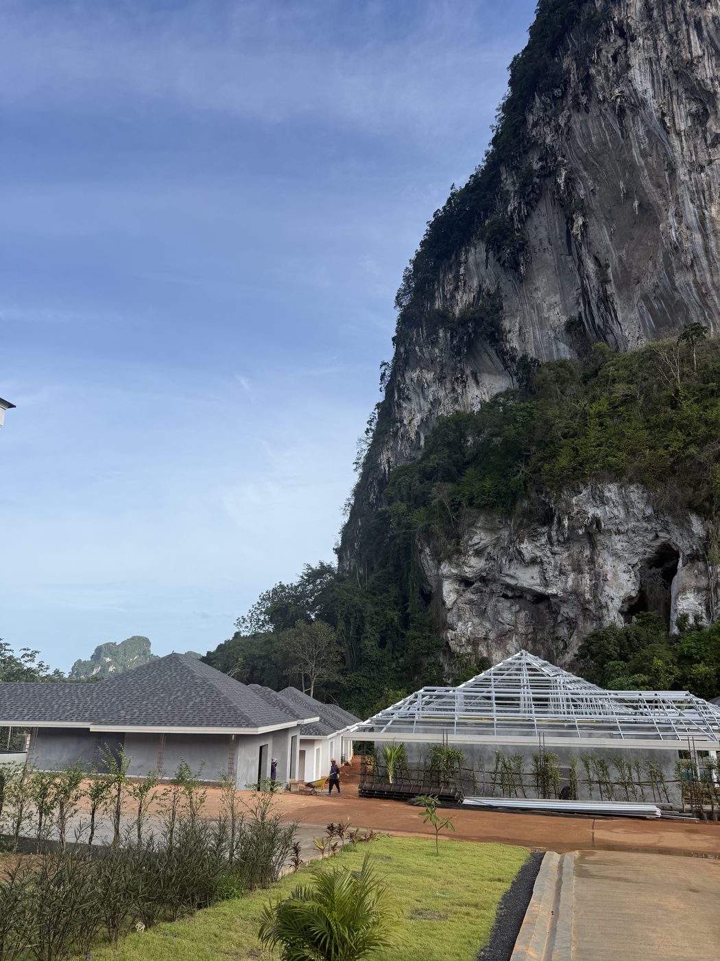 Villas under construction in front of a limestone cliff in southern Thailand